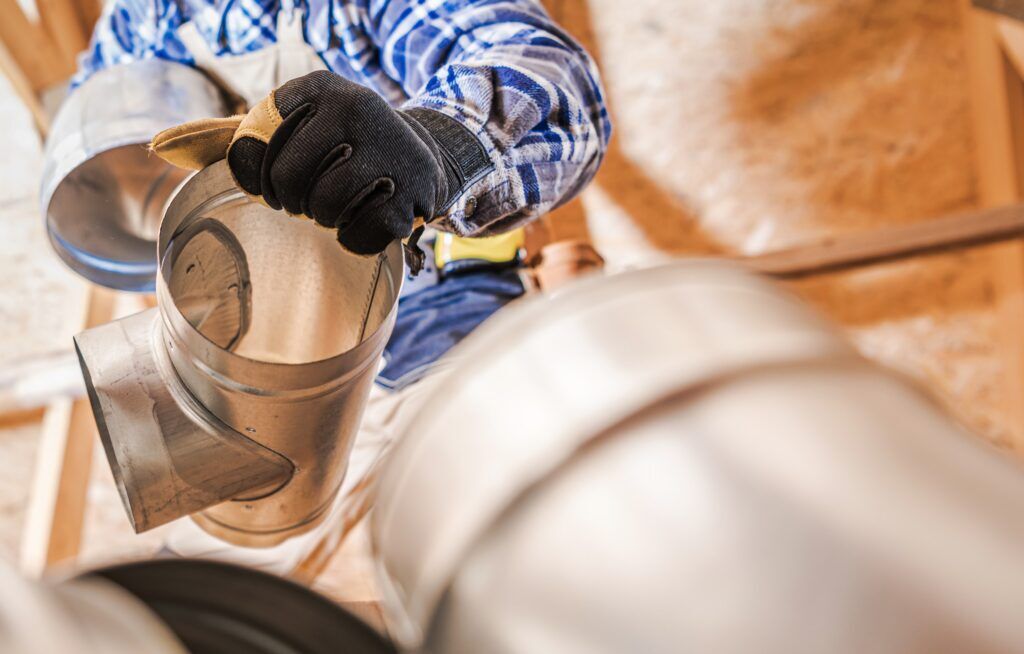 HVAC technician installing ductwork